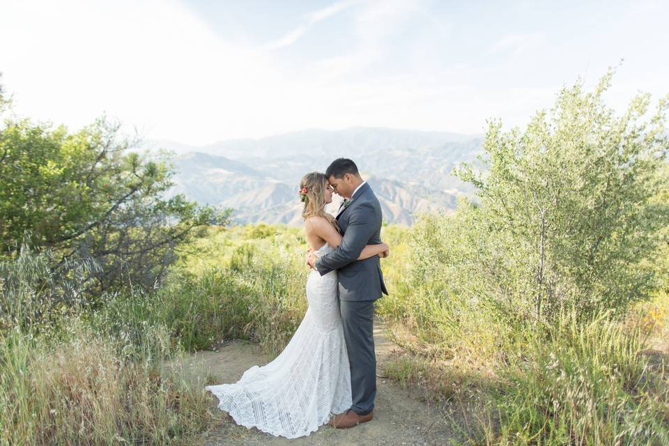 Newly weds beside a mountain