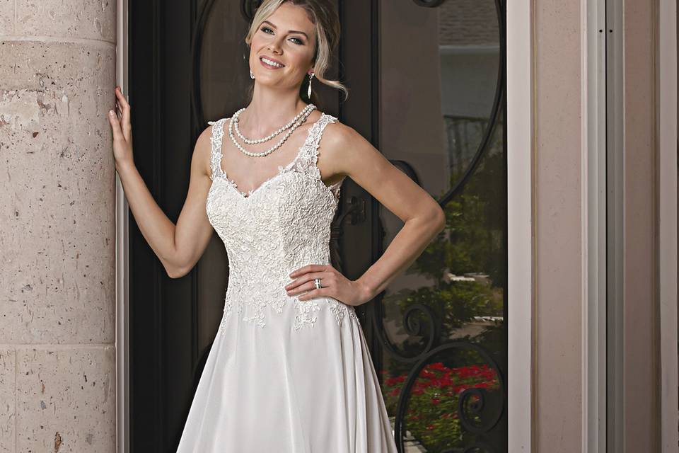 DaVinci Bridal Style #: 50362
Chiffon sweetheart tank covered in lace with straps that extend into a sheer heavily beaded illusion back.  A-line skirt is plain with a chapel length train.  Zipper back with buttons.