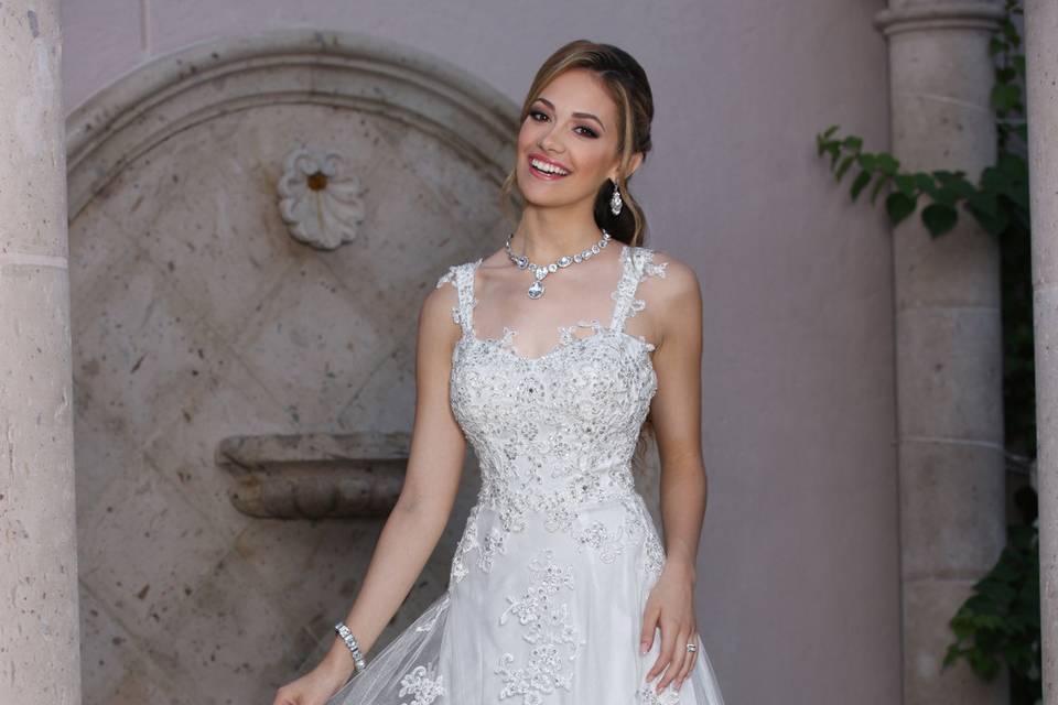 DaVinci Bridal Style #: 50361
Tulle over charmeuse with sweetheart tank and scattered lace throughout the bodice.  The heavily decorative straps extend into thin spaghetti straps accenting the low v-back.  Tulle slim A-line skirt has scattered lace and chapel length train.  Zipper back.