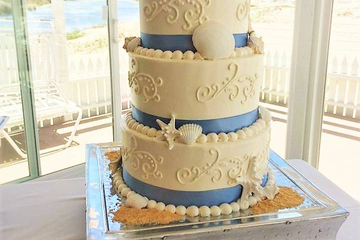 White and pink cake with figurines