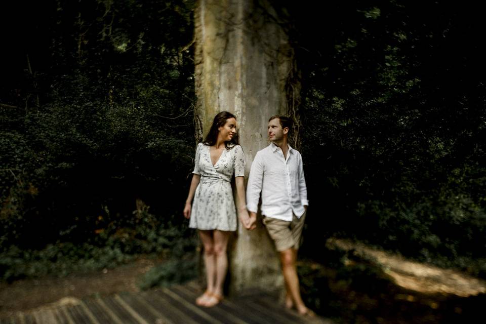 Couple leaning against a tree