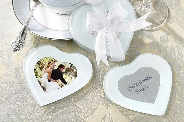 Invite your guests to fill their hearts with loving memories of your picture perfect day with these heart shaped photo coaster sets. Sold in sets of two, each 4 x 4 x 1/8 coaster is heart shaped glass with a white screened background and a heart shaped slot for a 2 ½ x 2 ½ photo. Each set is packaged in a clear plastic heart shaped box tied with a white organza ribbon.