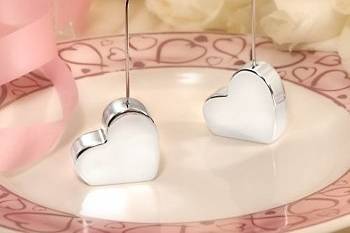 There will be cheerful signs of love throughout the room with these perfect-for-all-occasions favors decorating your tables. Each 5 x 1.75 place card holder features a silver plated solid heart-shaped base with a coiled wire holder at it top  ready to cheerfully display your event seating cards.