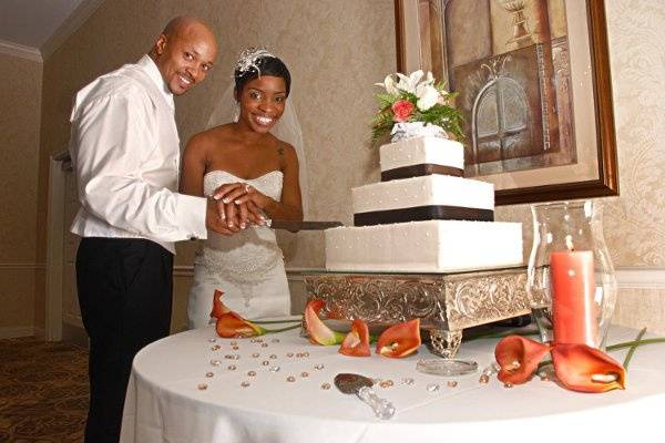 Bride & groom cutting cake at wedding reception