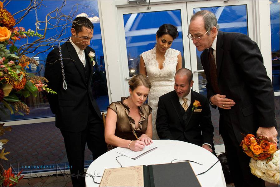Couple signing the marriage certificate