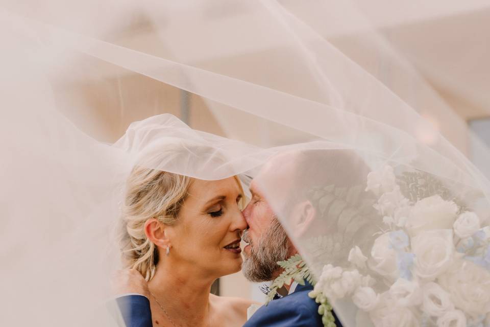 Bride and Groom Under Veil