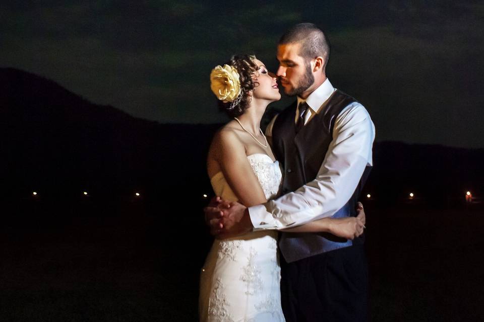 Lauren & Wes embracing under the moonlight after their wedding