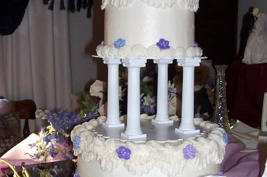 Buttercream iced cake with Royal icing apple blossoms decoration.