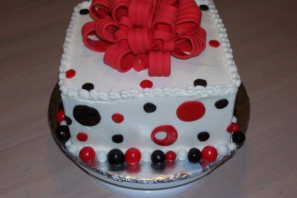 Buttercream iced cake w/ fondant Bow and polka dots.