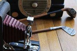 Vintage golf clubs, cameras, and radios are all great accent pieces for wedding reception decor and photo shoots
