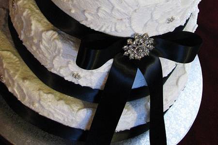 White wedding cake with black ribbon