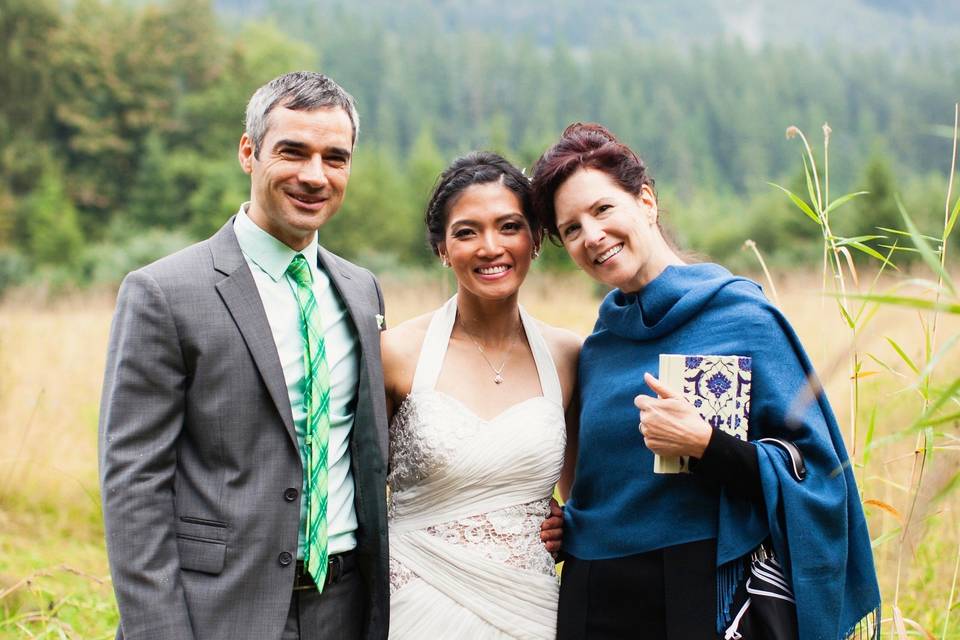 Newlyweds and their wedding officiant