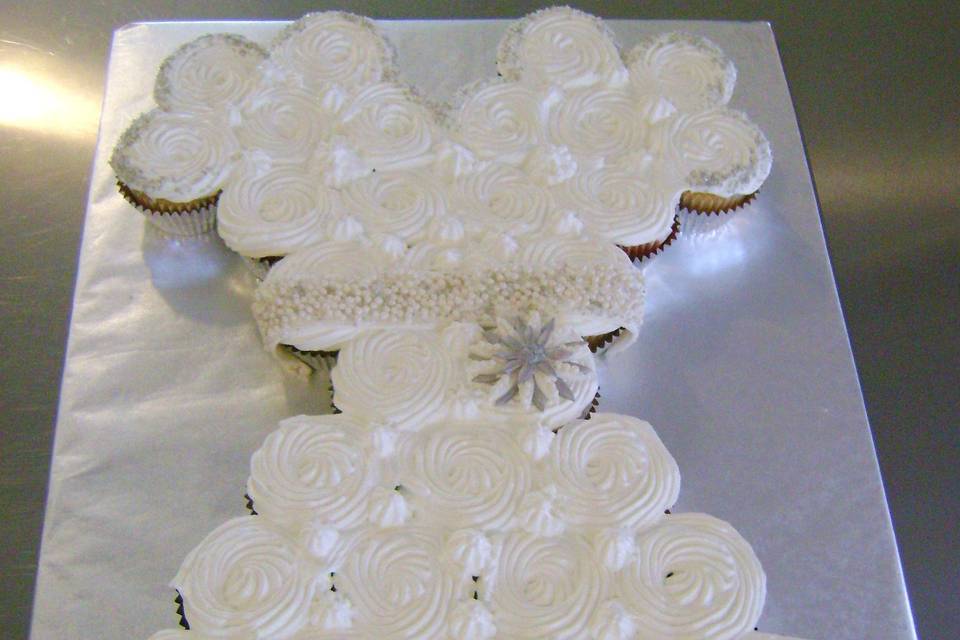 Wedding Dress Cupcakes!  Vanilla, Chocolate and Strawberry Cupcakes with Fluffy Vanilla Frosting. The Cupcakes are adorned with Pearl, Silver and Crystal Sprinkles.