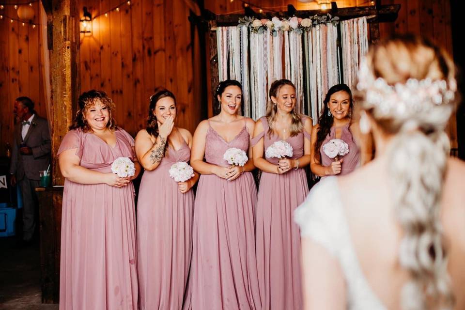 Bridesmaids looking at Bride