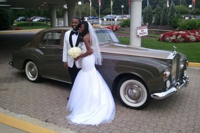 Couple posing with a vintage car