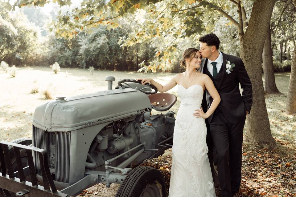 Couple by old tractor