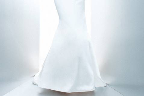Felicity:
Joy and luck are yours in this radiant silk shantung gown. Classical lines are evident from the slim A-line silhouette to the empire waist and strapless crumb-catcher neckline. Simple and clean vertical seaming is accented by covered buttons flowing down the back to the modified chapel-length train. White and off-white.