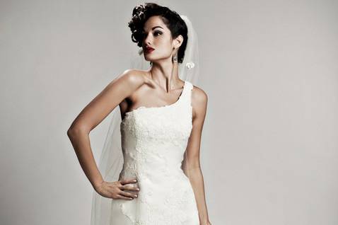 Bandeau:
Countless dimensional silk duchess bands encircle you in this intriguing combination of structure and dramatic side draping. The off the shoulder neckline and modified trumpet skirt add interest, completed with a modified chapel-length train. White and off-white.