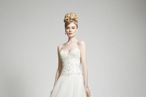 Style Cecilie <br> This sweet and classic trumpet gown is decorated with delicate corded, floral lace. With a figure flattering sweetheart neckline and full trumpet skirt, this dress is finished with covered buttons and a graceful lace border to the end of the modified chapel length train.