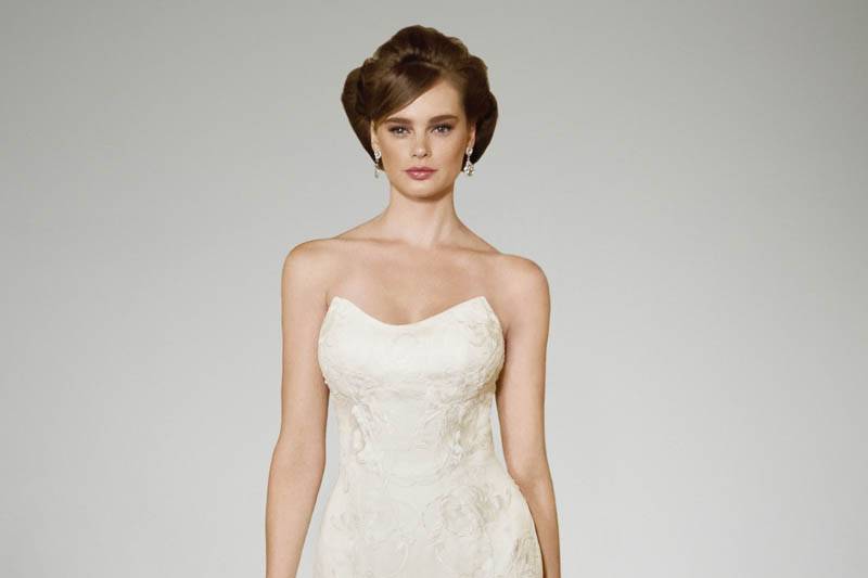 Style Emily <br>      	Your storybook romance finds love’s happy ending with this natural waist, A-line ball gown. A diaphanous bodice flatters with delicate straps and a flowering design, which enriches your feminine presence. A gossamer-thin V-shaped back neckline leads your eye down to a row of tulle covered buttons that caresses the natural waisted basqued seam. The A-line skirt is a floaty confection comprised of tulle layers, which are scattered with gorgeous blooming detailed lace and baby matte sequins.