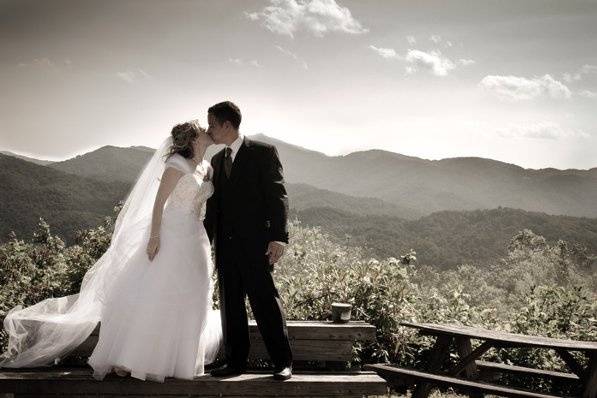 Just married. Couple kissing with the mountains in the background.