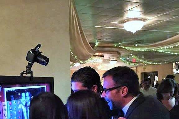 Guests huddled over the led screen