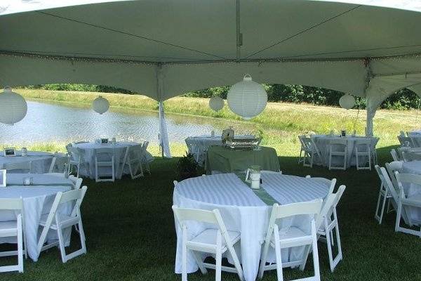 Dreamy white linens with light olive accents keep the look fresh and inviting.