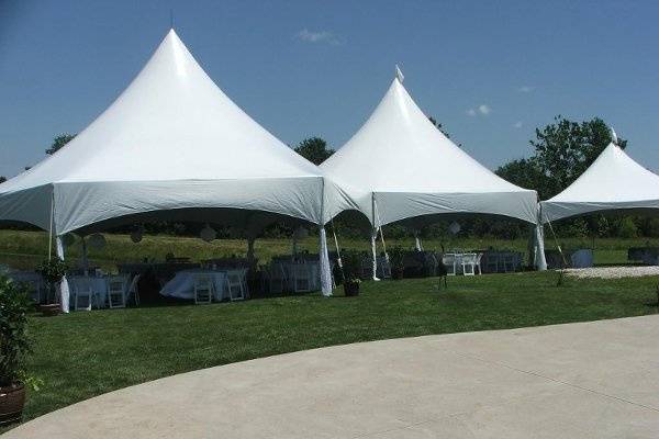 White tents against a blue sky