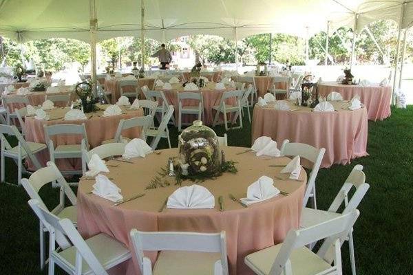 Beautiful peach and white linens give this spring reception the perfect base for the bride's personal centerpieces.