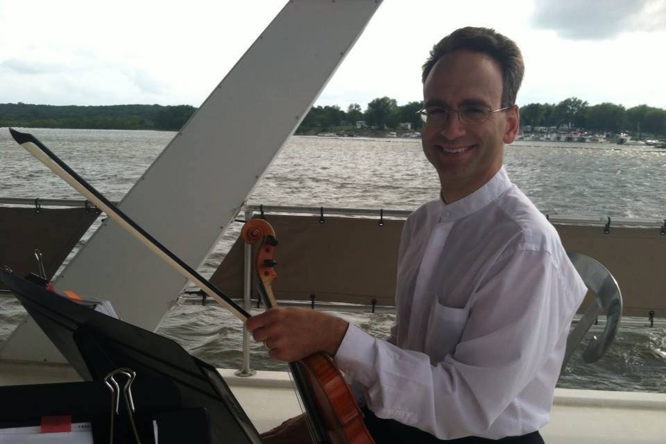Violinist Spencer Howard performs for Sight and Sound through Orchestra Iowa on a yacht!