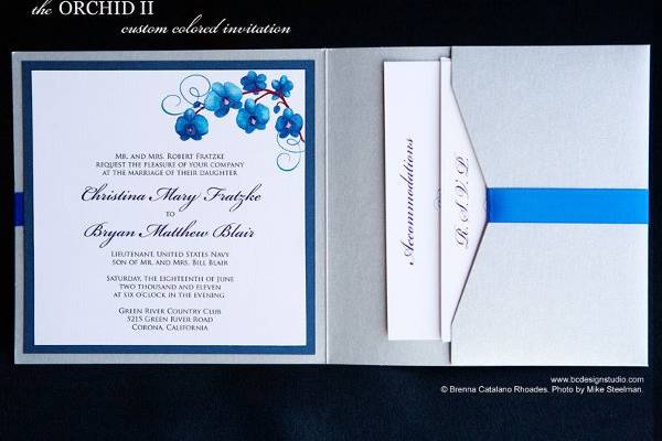 Custom Wedding invitation with blue Phalaenopsis Orchid motif by Brenna Catalano Design Studio. Tag on front with names and wedding date. Color and format can be customized.