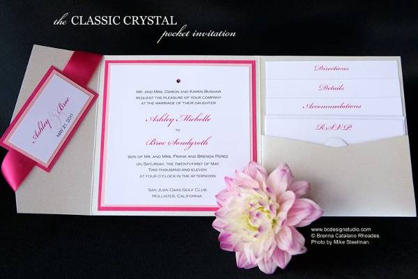 The Classic Crystal wedding invitation with double layered backing and crystal accent from Brenna Catalano Design Studio. Ribbon wrap with tag and pocket to hold insert cards. Colors can be customized