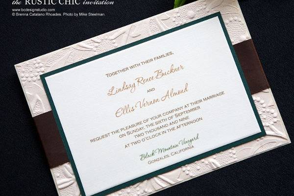 The Rustic Chic invitation with embossed natural paper and satin ribbon from Brenna Catalano Design Studio. Colors can be customized.