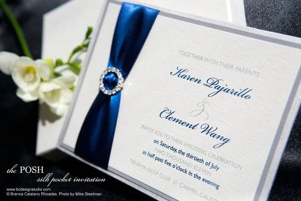 The Posh Silk wedding invitation with crystal buckle and satin ribbon from Brenna Catalano Design Studio. Pocket on back to hold insert cards and box mailer.