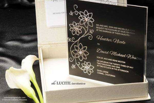 The modern Lucite wedding invitation is printed on plexiglas and accented with Swarovski crystals. Comes in an envelope but can be upgraded to a silk box. Design and color is customizable.