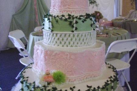 SERENITY:  This 4-tier cake with it's garden lattice work and vines placed in tandem with the delicate lace of the other 2 tier is both beautiful and serene.