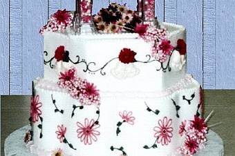 DAISY DELIGHT:  Beautiful but simple too!  This 3-tier cake is embellished with daisies, bells, and vines.