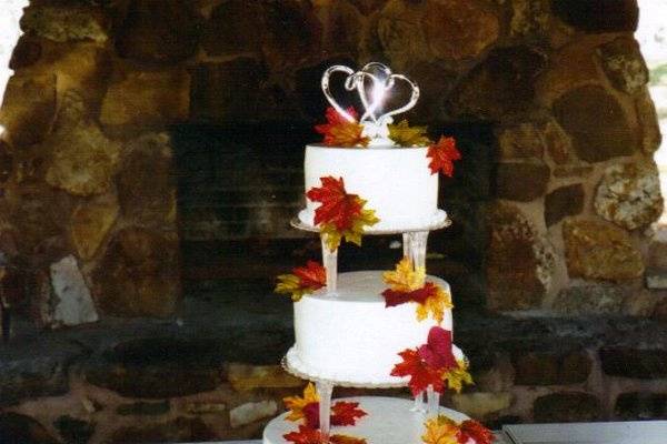AUTUMN SIMPLICITY:  This 3-tier cake is simple but elegant with beautiful fall leaves drifting down the sides with quiet beauty.