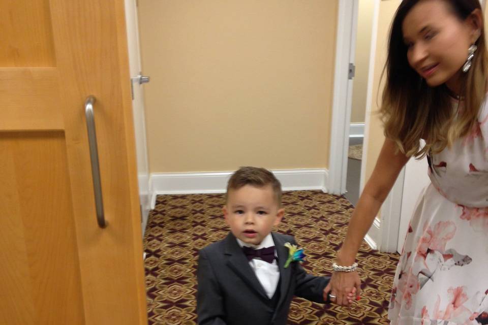 Cute ring bearer with a small version of the Groom's boutonnière.