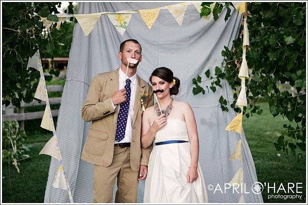 Bride & Groom have some fun with their own homemade photobooth at Chatfield Botanic Gardens in Littleton, CO