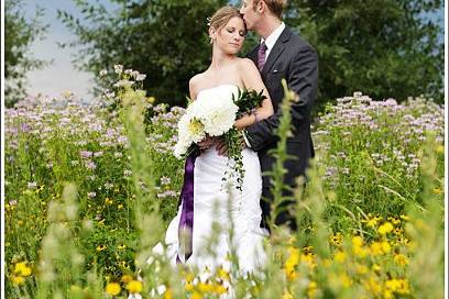 Romantic photo of a bride and groom at Chatfield Botanic Gardens in the summertime.
