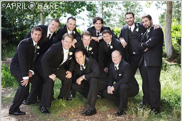 A groom with his groomsmen pose near the REI in downtown Denver, CO