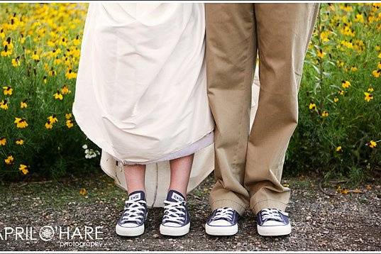 Bride & groom wearing blue Chuck Taylor All Star sneakers pose together in the garden at Chatfield Botanic Gardens in Littleton, CO