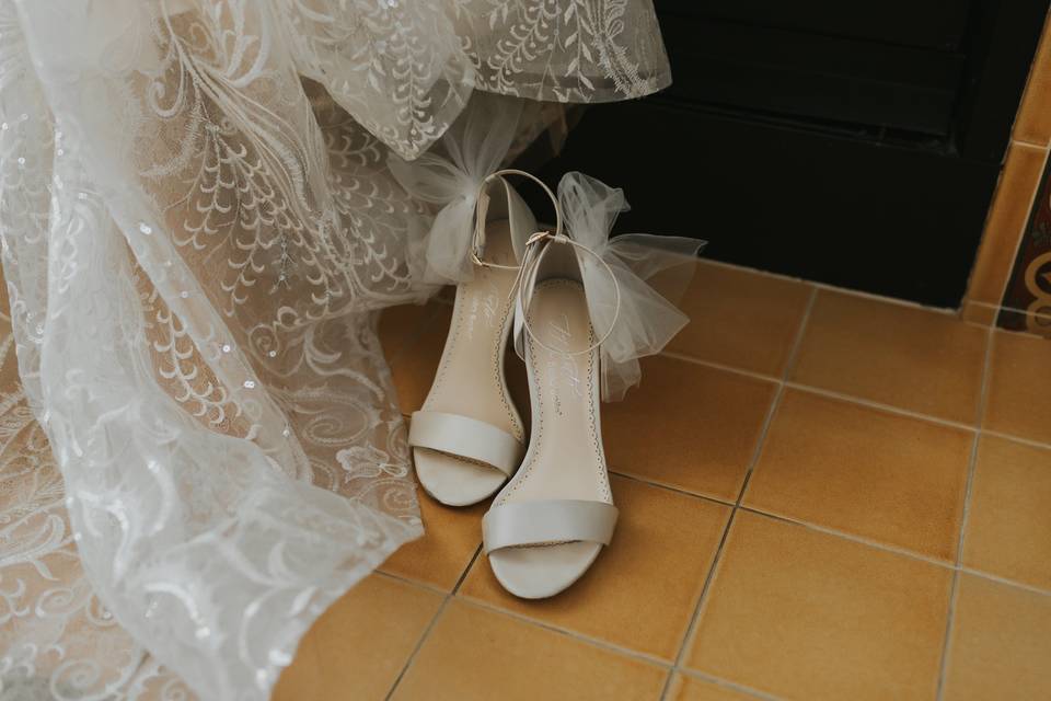 Shoes next to wedding dress