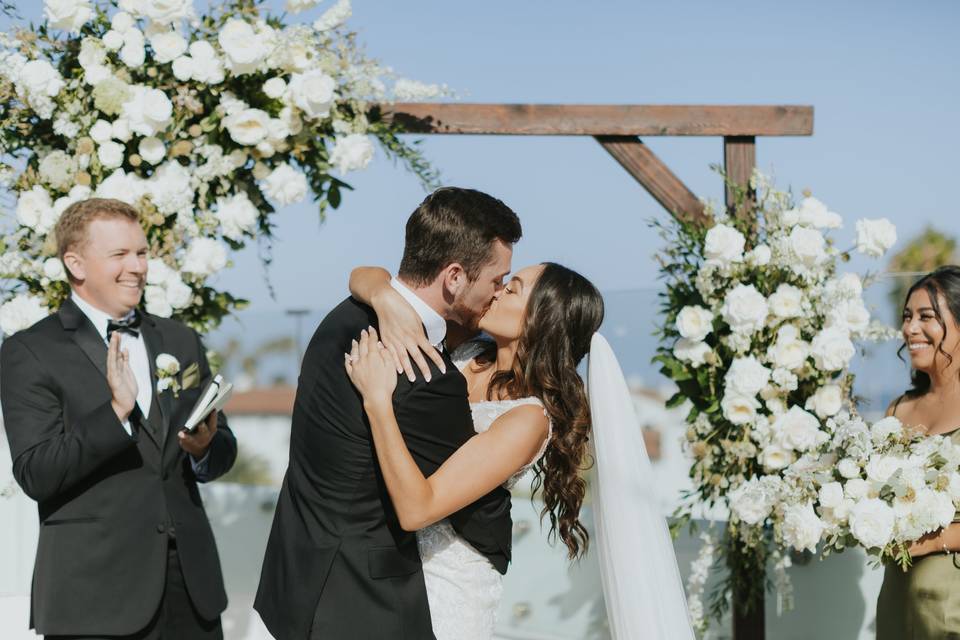 Bride and groom kiss at altar