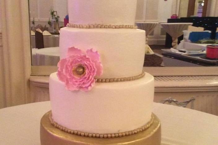 Four tier pink and gold cake