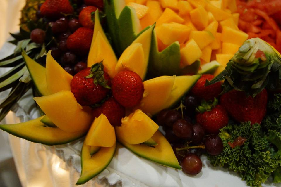 Carved melon garnish with fresh fruit display