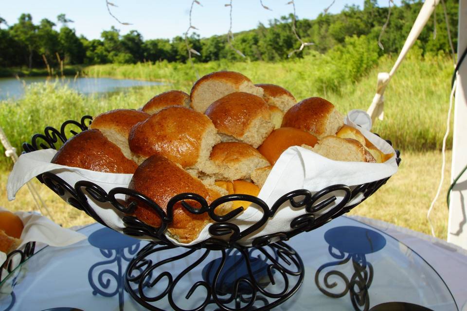 Fresh baked dinner rolls at a tent reception