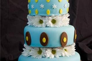 This is a 3 tier sky blue cake with white and yellow daisies. Very elegant with a touch of happiness.