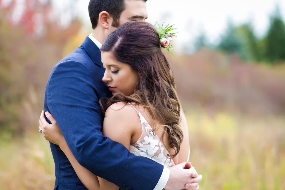 Groom hugging bride